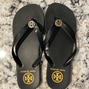 Tory Burch flip flops. Black with gold emblem. EUC